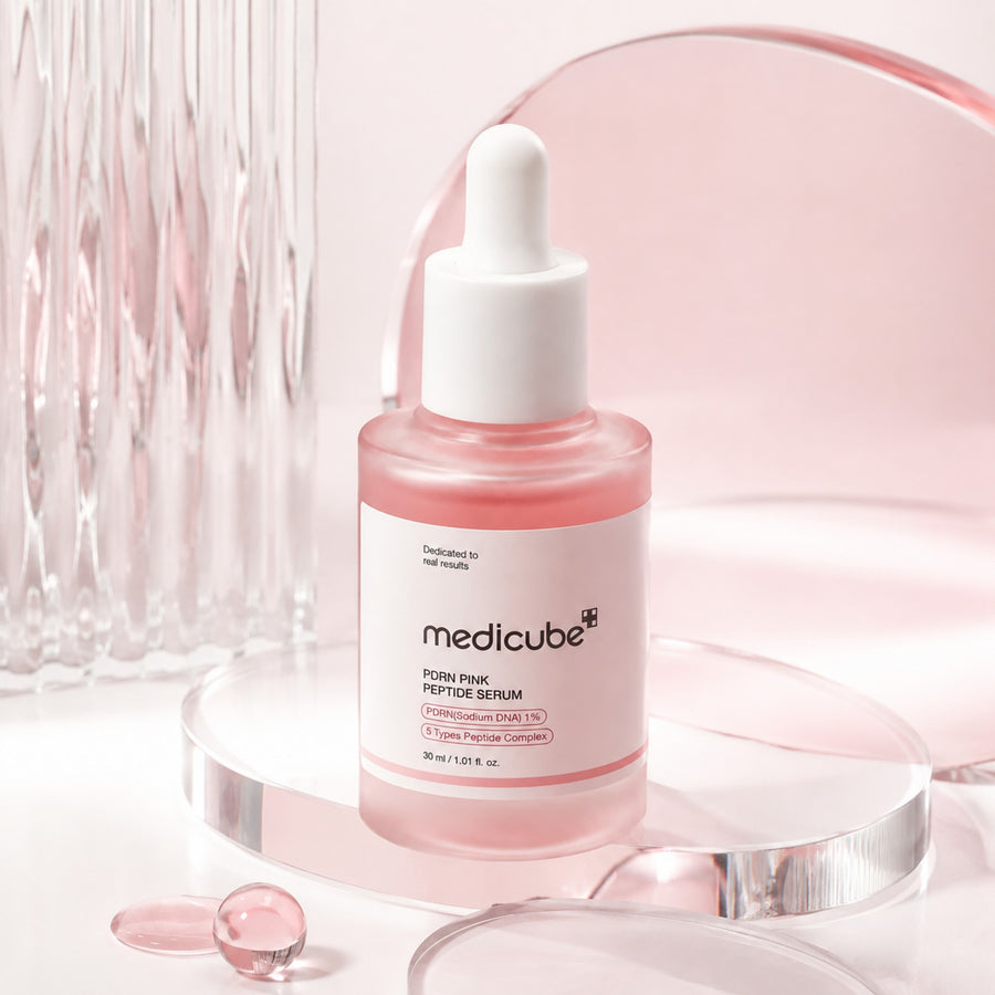 Kit Pink Glow MEDICUBE: sérum PDRN Pink Peptide Serum sobre un podio de cristal
